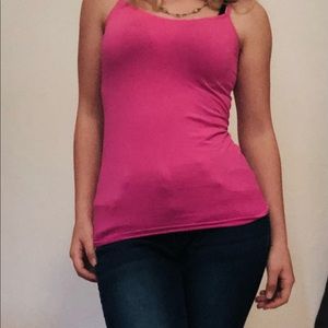 Small women’s “Jones New York” pants and bright pink tank top.